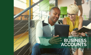 Man and woman smiling at a tablet in a coworking space - Small Business Accounts Ad